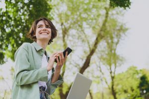 a student holding her phone and smiling