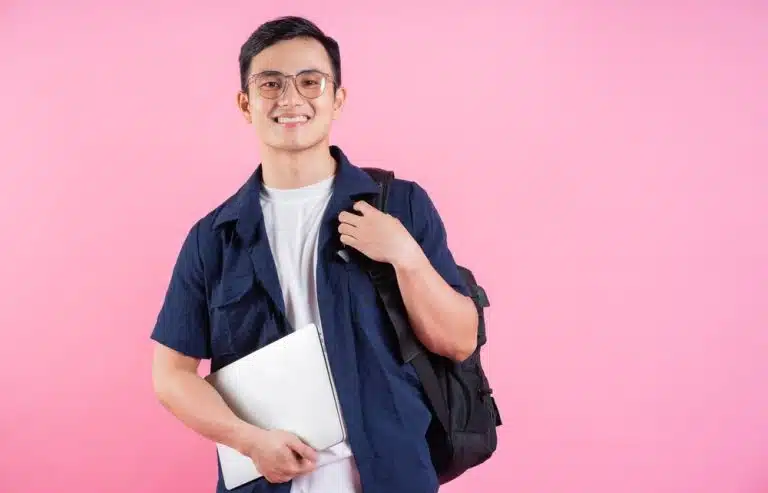 A male student looks at the camera while considering Smith vs Wellesley.