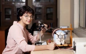 a female student working on a microscope