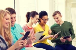 Group of students looking at their gadget.