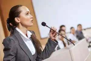 Young woman speaking in public.