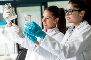 two women examining a specimen