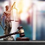 A lady justice figurine and mortar and gavel