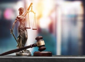 A lady justice figurine and mortar and gavel