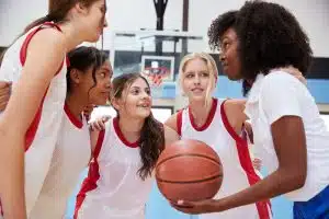 female basketball players strategizing during a break