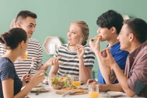 View of students eating in a table.