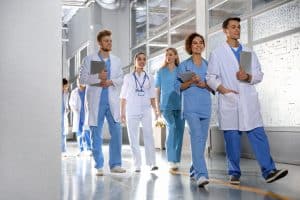 a group of medical school students walking through a hallway