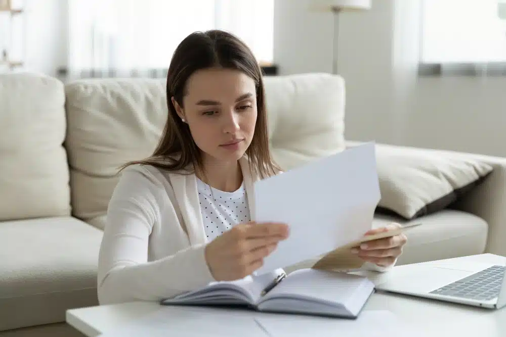 a female student reading a college decline letter