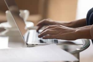 Using a laptop and typing in a table.