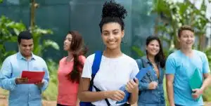 Laughing indian female student with group of multi ethnic young adults outdoor