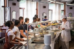 Students Being Served Meal In School Canteen