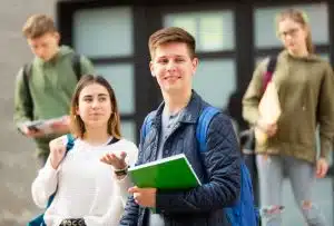 Group of students walking next to a building.