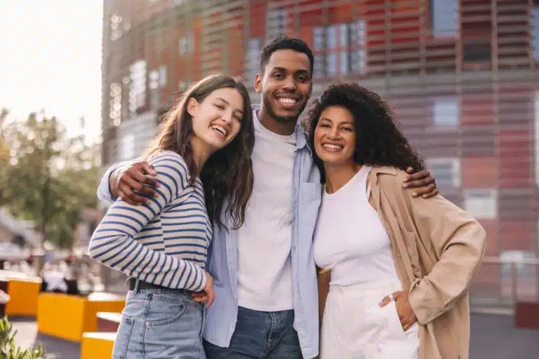 Three students smiling for the camera.