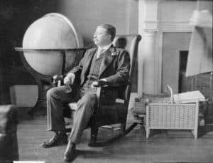 Theodore Roosevelt sitting on a rocking chair