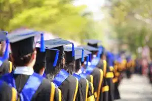 a line of graduates wearing their graduation gowns