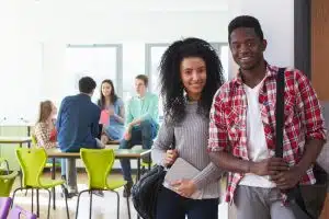 a male and female college students standing at a doorway