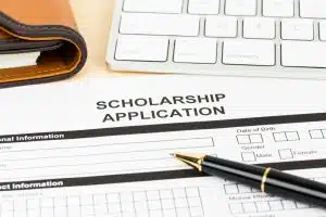 Scholarship application form with keyboard and pen