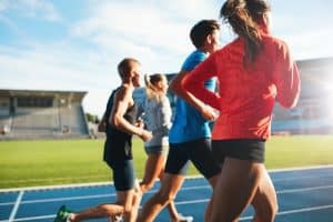 athletes running in the oval field