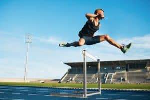 a hurdle jump athlete running