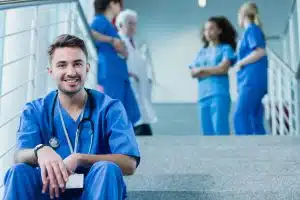 a medicine student sitting at the staircase looking at the camera