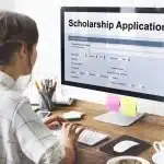 a female student filling out a scholarship application form