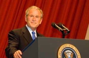 George W. Bush on a podium in the middle of a press conference