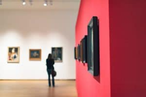 A woman looking at paintings in the Museum of Modern Art