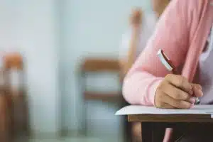 unidentified student taking an exam inside a class