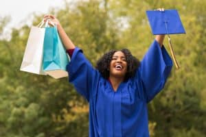 View of a female student holding a graduation gift.
