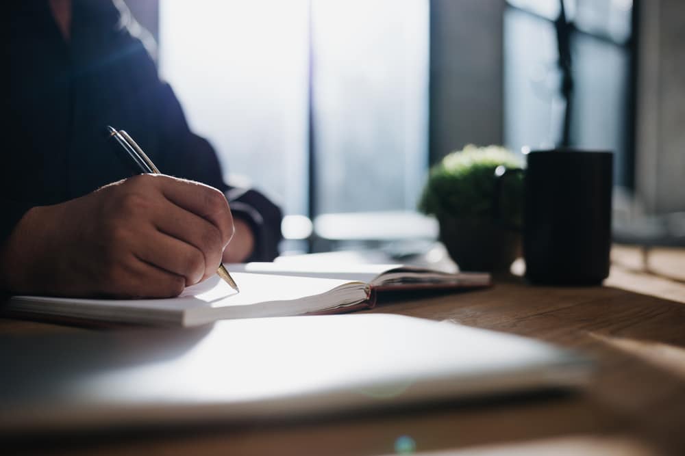 A writer scribbling in her notebook.