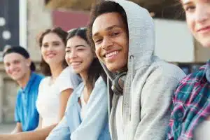 Group of students laughing at each other.