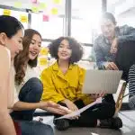 Students particpating in Digital4Good programs sitting and sharing creative ideas.