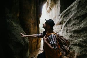 A young male geologist explores a mountain cave