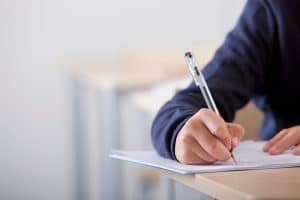 A close up of a student taking an exam.