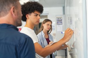 View of a students writing in the board.