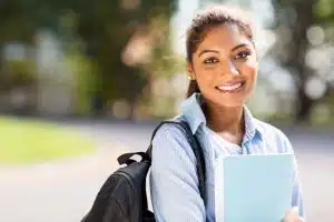 female college student on campus and looking at the camera