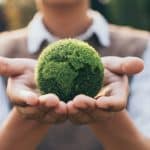 A student holding a model of the earth