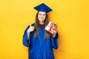 A female student holding her graduation gift.