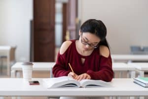 Asian student studying for an exam.