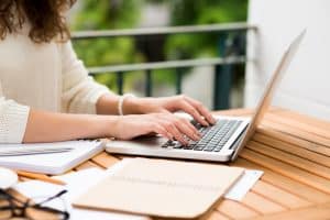 Side view of a woman using her laptop.