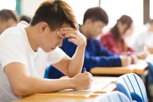 Group of students taking an exam for college admission