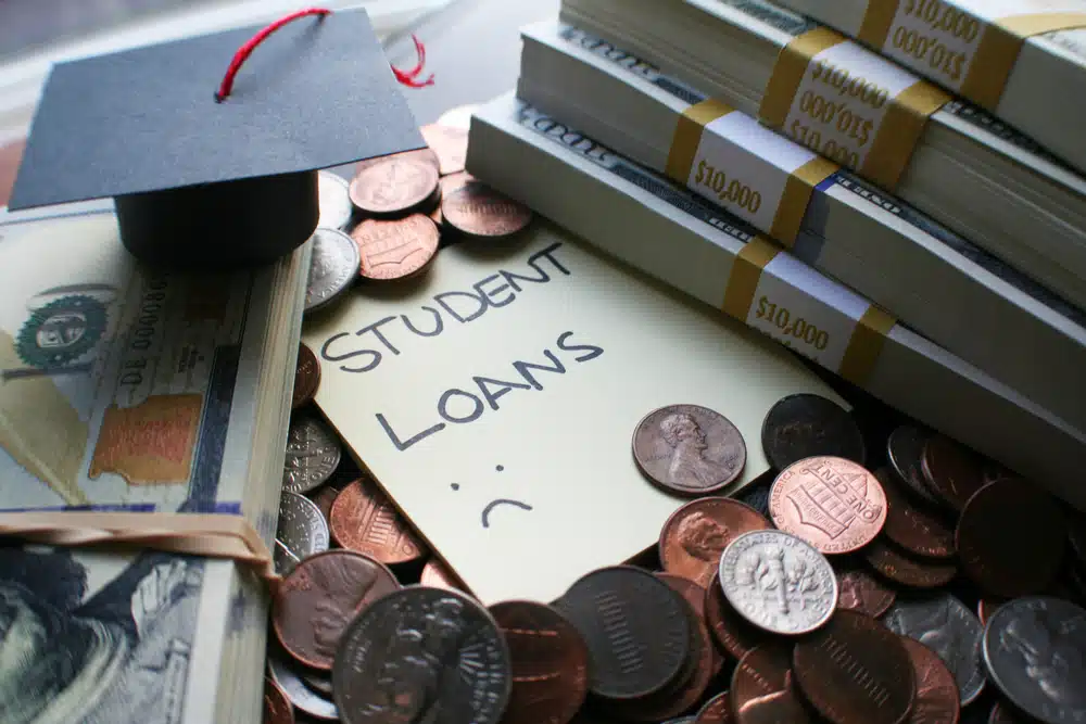 View of coins and money placed next to a label of student debt.