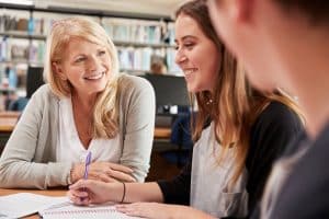 Female teacher talking to her students.