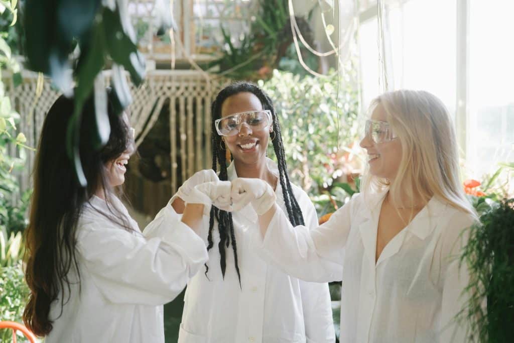 Students of science fist-bumping