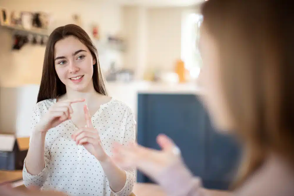 Two Teenage Girls Having Conversation Using Sign Language