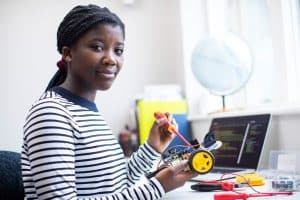 Female student working on a robot.