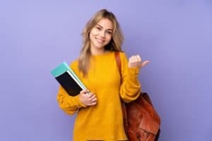 sorority member isolated on purple background with thumbs up gesture and smiling