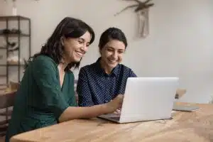 Two women checking something on a site.