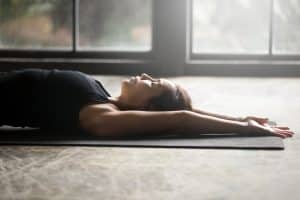 A young woman relaxing in a Yoga mat