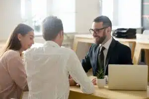 A financial advisor in suit consulting young couple